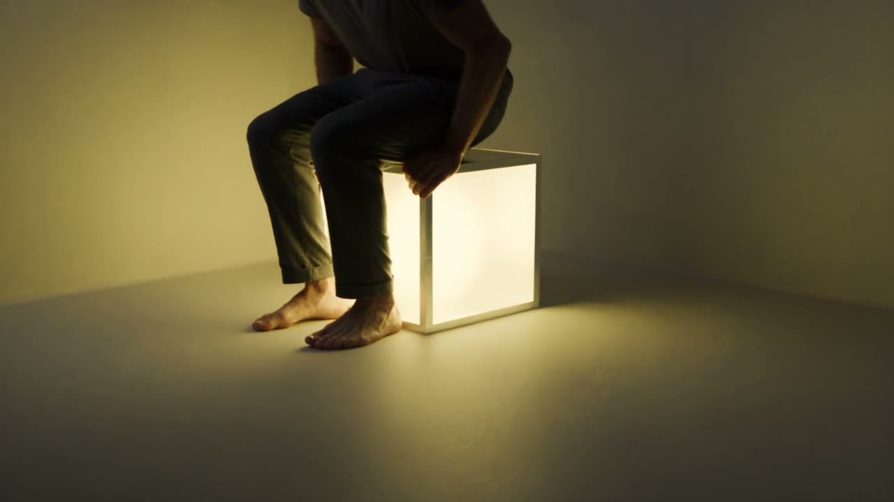 Yellow Box: a cube seat that glows warm yellow while someone sits on it.